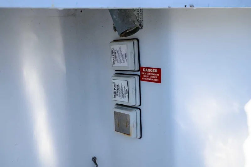Slide: The Image of Electrical panel with warning label on 1997 Mainship 350 Trawler boat. - 26