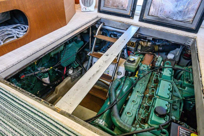 Slide: The Image of Engine room of a 1997 Mainship 350 Trawler, showcasing mechanical components and equipment. - 48