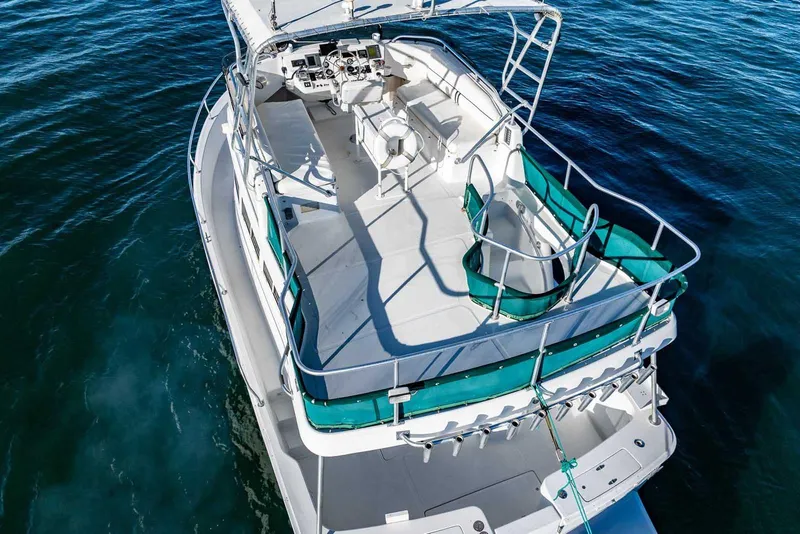 Slide: The Image of 1997 Mainship 350 Trawler on water, aerial view of deck and helm. - 7