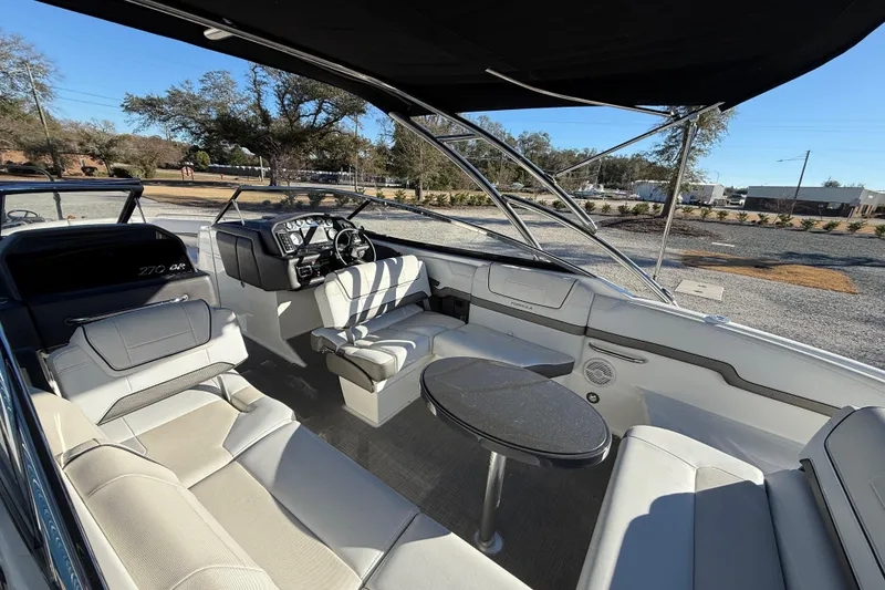 Slide: The Image of 2019 Formula 270 Bowrider interior with seating, steering wheel, and table under canopy. - 10