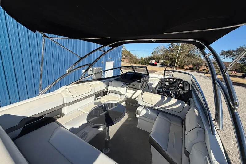 Slide: The Image of 2019 Formula 270 Bowrider interior with seating, steering console, and table under canopy. - 12