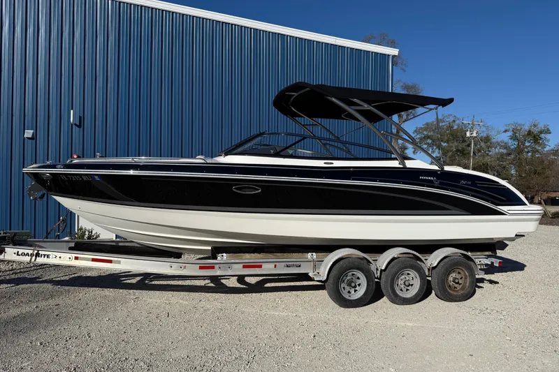 Slide: The Image of 2019 Formula 270 Bowrider boat on trailer, parked by blue building. - 4