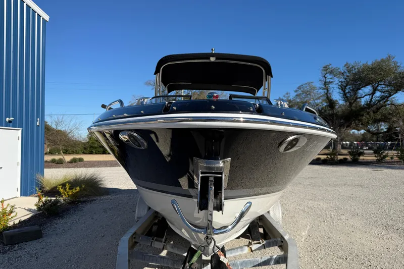 Slide: The Image of 2019 Formula 270 Bowrider boat on trailer, parked outdoors under clear blue sky. - 6