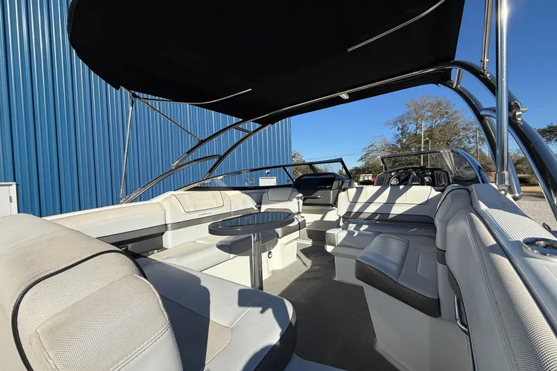 Slide: The Image of 2019 Formula 270 Bowrider interior with seating, table, and canopy under blue sky. - 8