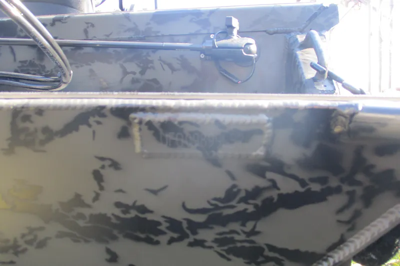 Slide: The Image of 2026 Gator Tail 1860 Extreme boat with camouflage pattern and mounted equipment. - 11