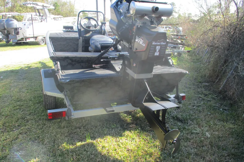 Slide: The Image of 2026 Gator Tail 1860 Extreme boat with powerful outboard motor on grassy area. - 4