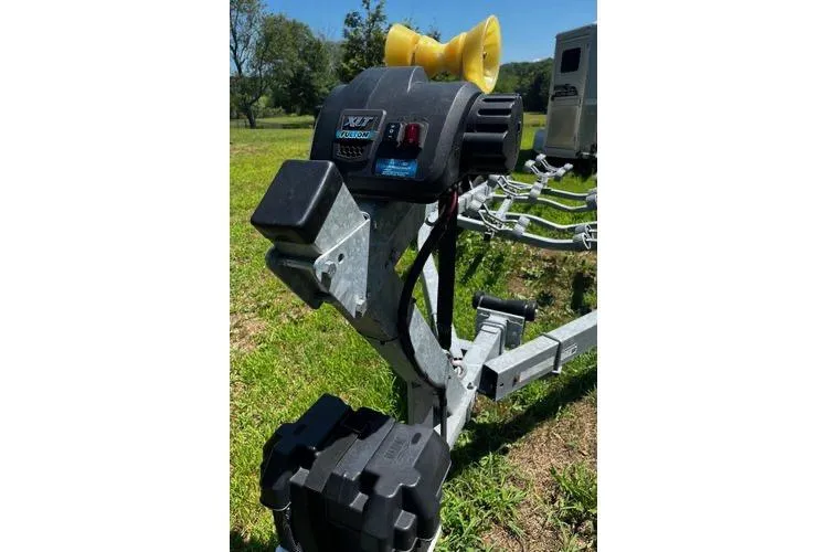 Slide: The Image of Trailer hitch for 2022 NorthCoast 215 Cabin boat on grassy field. - 17