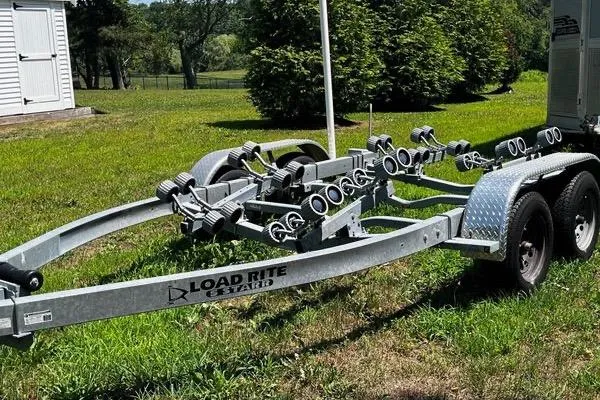 Slide: The Image of Boat trailer for NorthCoast 215 Cabin 2022, parked on grass, featuring Load Rite branding. - 18