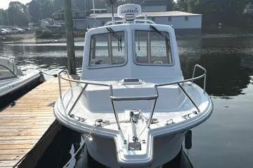 Slide: The Image of 2022 NorthCoast 215 Cabin boat docked at a marina, front view. - 2
