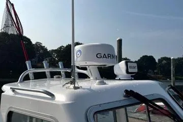 Slide: The Image of 2022 NorthCoast 215 Cabin boat with Garmin radar and fishing net on roof. - 3