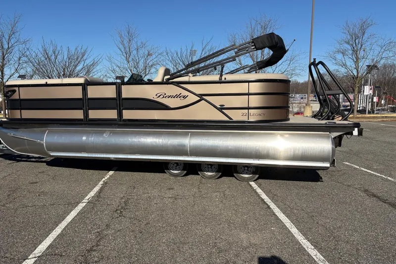 Slide: The Image of 2026 Bentley Pontoons Legacy 223 Navigator in a parking lot, side view. - 1