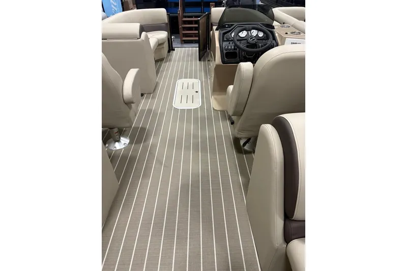 Slide: The Image of 2026 Bentley Pontoons Legacy 223 Navigator interior with beige seating and striped flooring. - 13