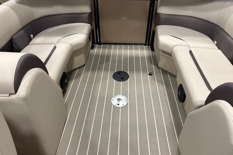 Slide: The Image of Interior of 2026 Bentley Pontoons Legacy 223 Navigator with beige seating and striped flooring. - 14