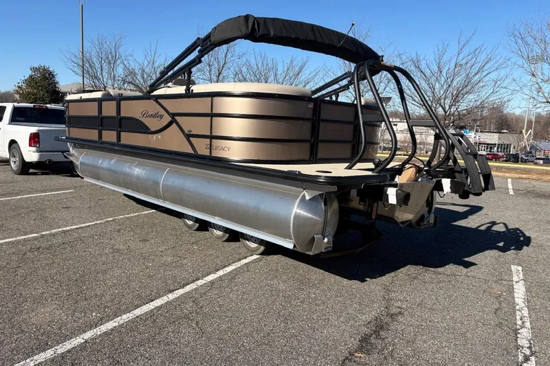 Slide: The Image of 2026 Bentley Pontoons Legacy 223 Navigator on trailer in parking lot. - 2