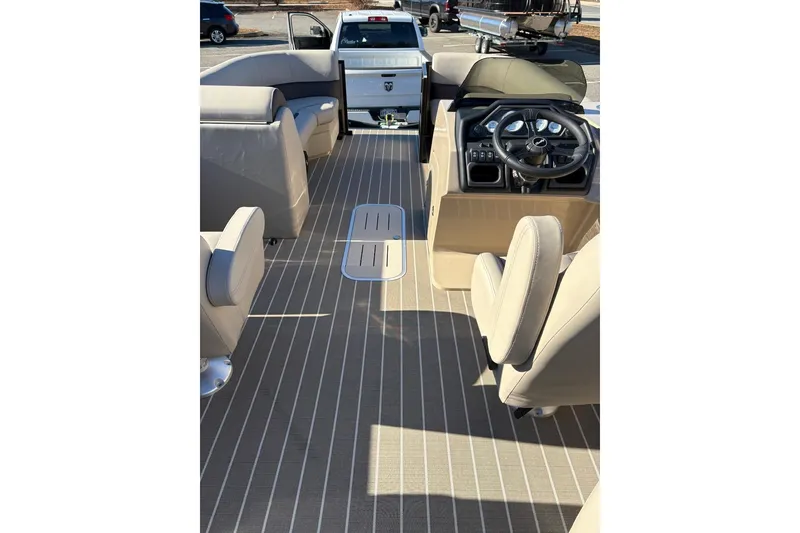 Slide: The Image of Interior of 2026 Bentley Pontoons Legacy 223 Navigator with beige seating and steering console. - 7