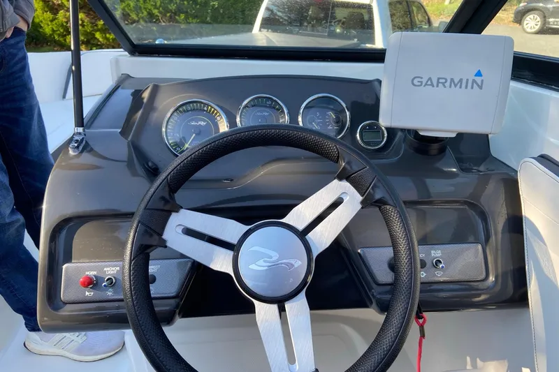 Slide: The Image of 2016 Sea Ray SPX 210 Outboard dashboard with Garmin navigation system and steering wheel. - 11