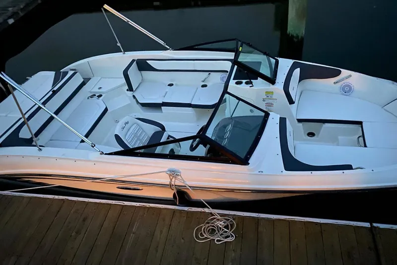 Slide: The Image of 2016 Sea Ray SPX 210 Outboard boat docked, featuring spacious seating and sleek design. - 15