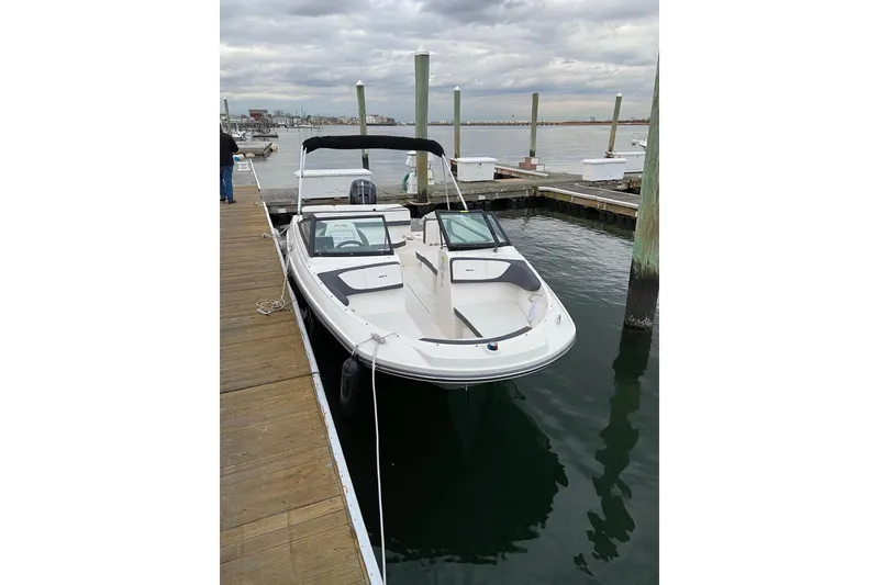 Slide: The Image of 2016 Sea Ray SPX 210 Outboard boat docked at marina under cloudy sky. - 3