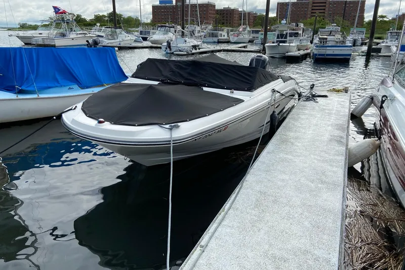 Slide: The Image of 2016 Sea Ray SPX 210 Outboard boat docked at marina, covered and secured. - 5