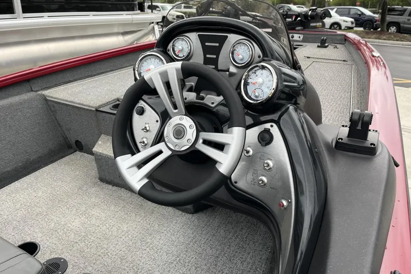 Slide: The Image of 2024 Tracker Pro Team 190 boat dashboard with steering wheel and gauges. - 5