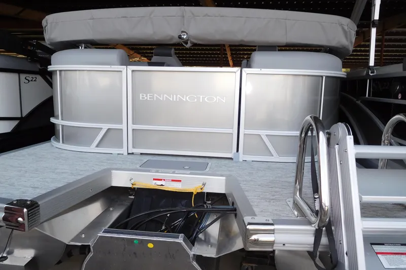 The Image of 2026 Bennington 22SSRSF pontoon boat, silver exterior, docked with visible ladder. - 1