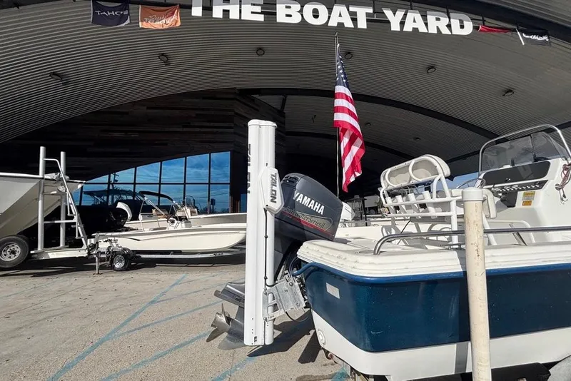 Slide: The Image of 2001 Bay Stealth 2230 boat at The Boat Yard with Yamaha motor and American flag. - 8