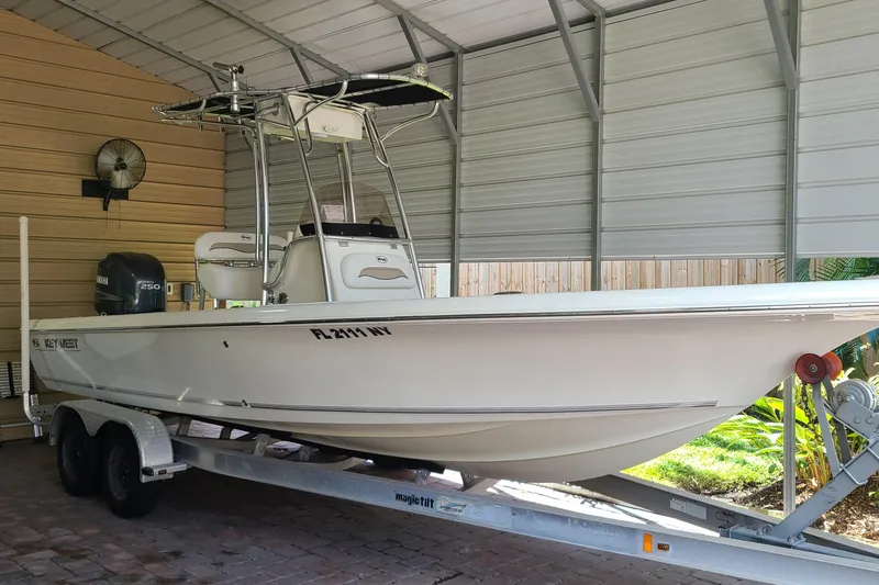 The Image of 2008 Key West 246 Bay Reef boat on trailer in covered storage. - 0