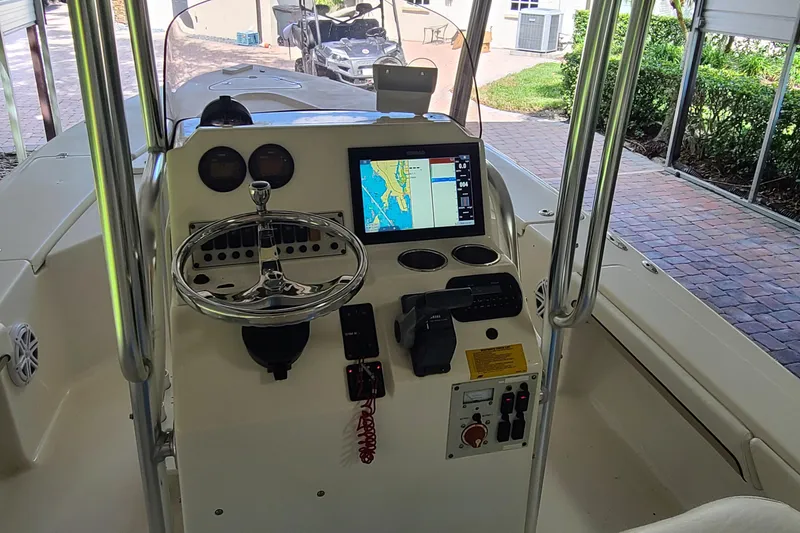 Slide: The Image of 2008 Key West 246 Bay Reef boat dashboard with navigation screen and steering wheel. - 13