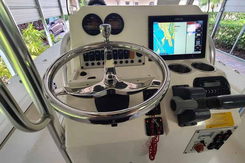 Slide: The Image of Steering console of 2008 Key West 246 Bay Reef boat with navigation display. - 14