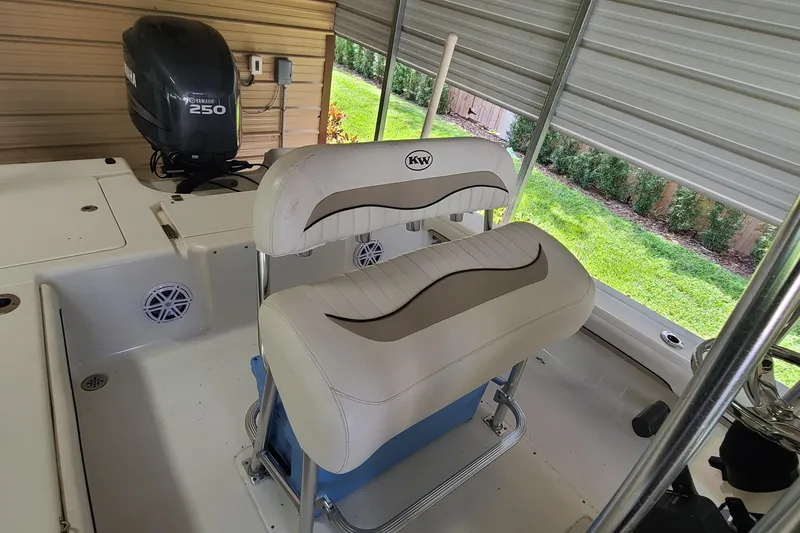 Slide: The Image of 2008 Key West 246 Bay Reef boat interior with Yamaha 250 engine and cushioned seating. - 17