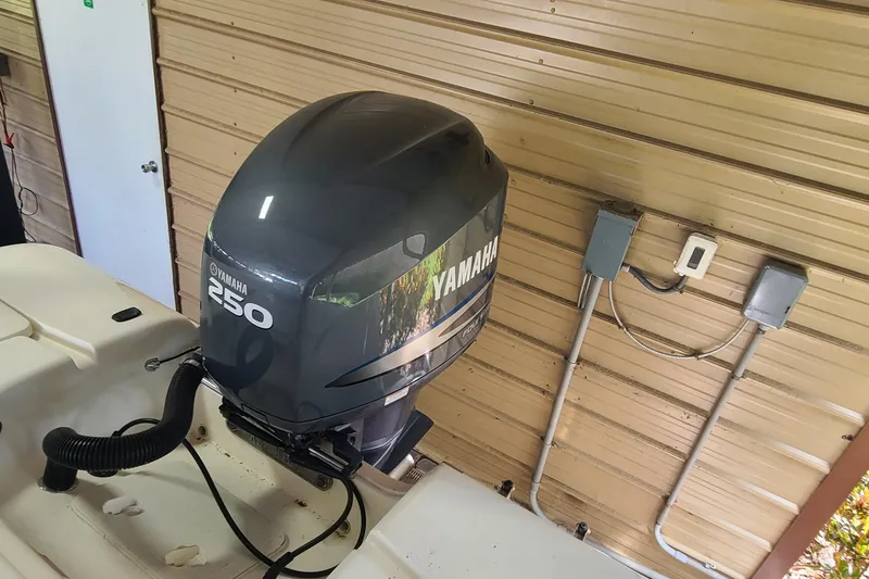 Slide: The Image of 2008 Key West 246 Bay Reef with Yamaha 250 outboard motor in garage. - 18