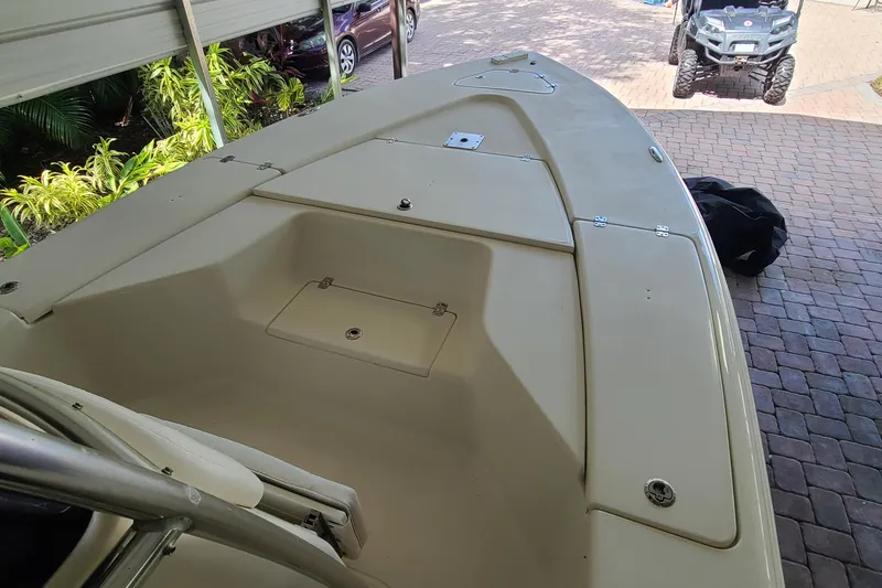 Slide: The Image of 2008 Key West 246 Bay Reef boat deck under a covered area with greenery. - 2