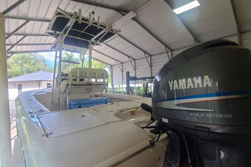 Slide: The Image of 2008 Key West 246 Bay Reef boat with Yamaha four-stroke engine in covered storage. - 22