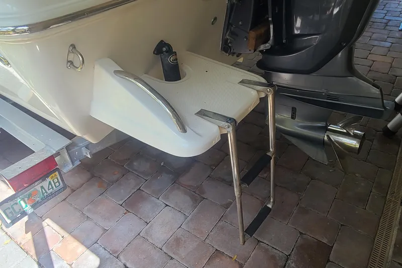 Slide: The Image of 2008 Key West 246 Bay Reef boat with ladder and motor on brick driveway. - 23