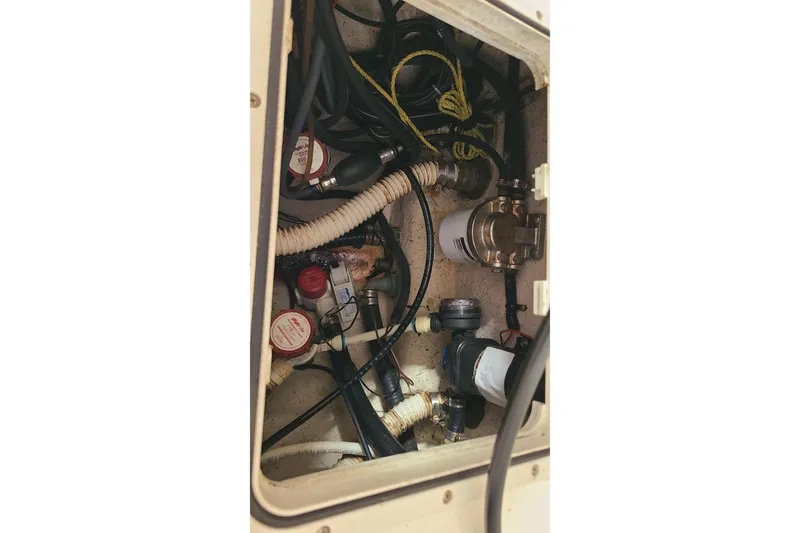 Slide: The Image of Bilge area of a 2008 Key West 246 Bay Reef boat, showing hoses and equipment. - 25