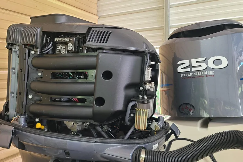 Slide: The Image of Open Yamaha 250 four-stroke outboard engine on a 2008 Key West 246 Bay Reef boat. - 26