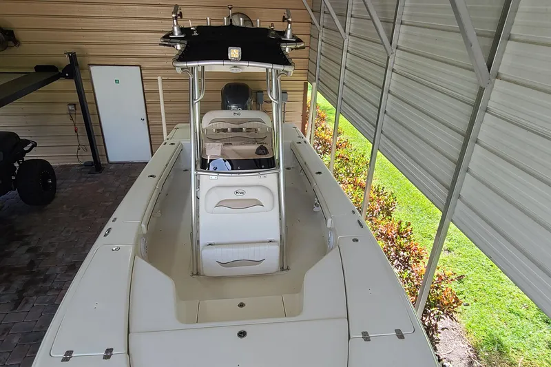 Slide: The Image of 2008 Key West 246 Bay Reef boat under metal shelter, side view. - 6