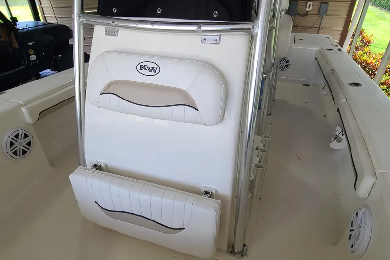 Slide: The Image of 2008 Key West 246 Bay Reef boat interior with white seating and rod holders. - 7