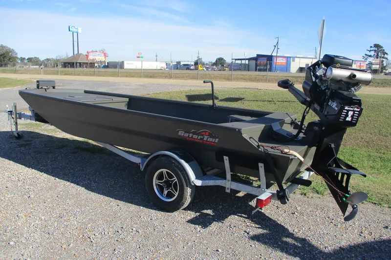 Slide: The Image of 2026 Gator Tail 1860 Extreme boat on trailer, parked outdoors. - 2
