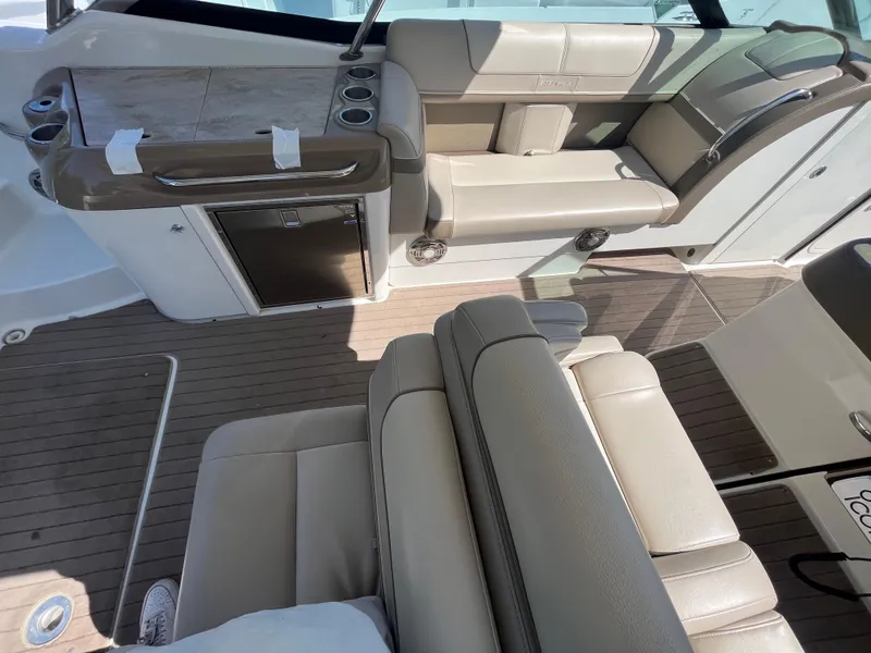 Slide: The Image of 2014 Formula 350 Crossover Bowrider interior with beige seating and wood accents. - 11