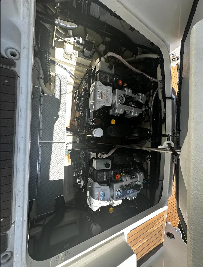 Slide: The Image of Engine compartment of a 2014 Formula 350 Crossover Bowrider, showcasing dual engines. - 14