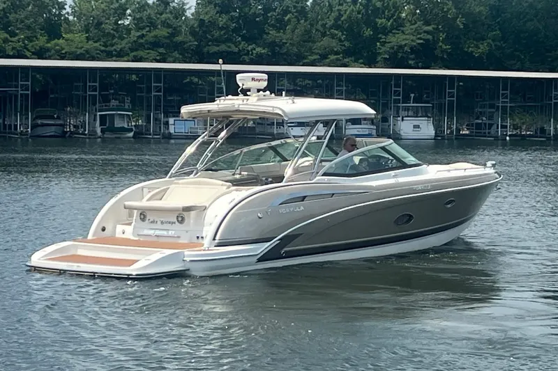 Slide: The Image of 2014 Formula 350 Crossover Bowrider on water near marina, showcasing sleek design. - 4