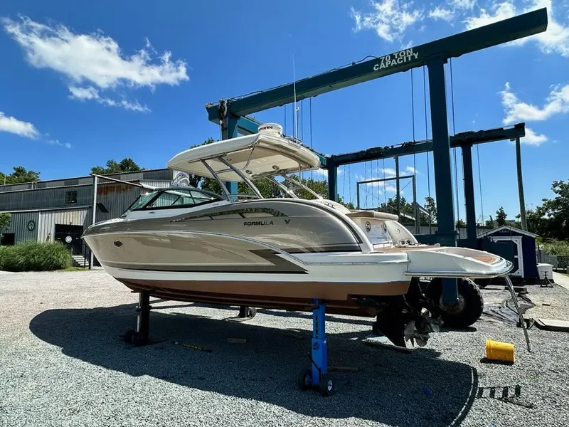 Slide: The Image of 2014 Formula 350 Crossover Bowrider on dry dock under clear blue sky. - 7
