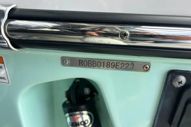 Slide: The Image of 2023 Robalo R242 Center Console dashboard with controls and steering wheel. - 14