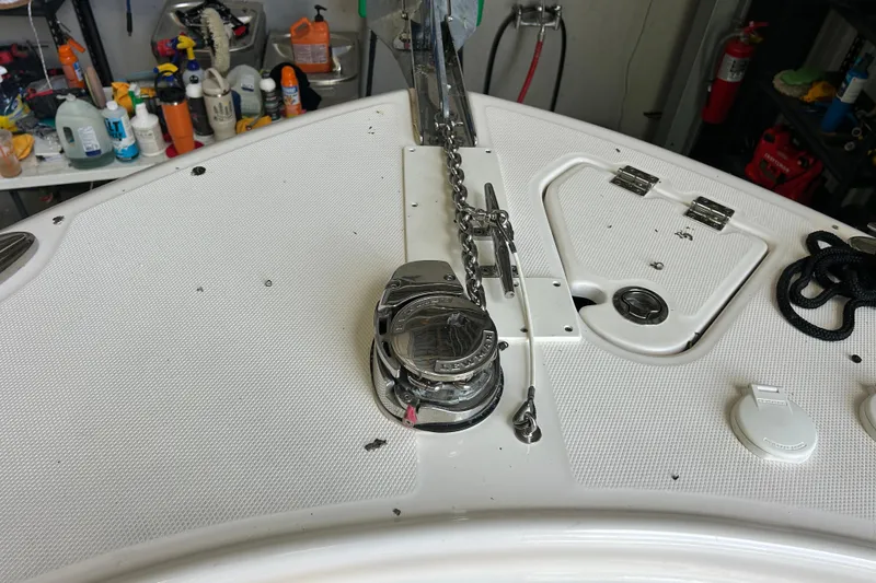 Slide: The Image of 2023 Robalo R242 Center Console boat deck with anchor chain and storage compartments. - 17