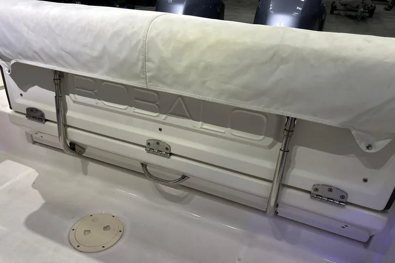 Slide: The Image of 2023 Robalo R242 Center Console boat with covered seating and visible branding. - 22