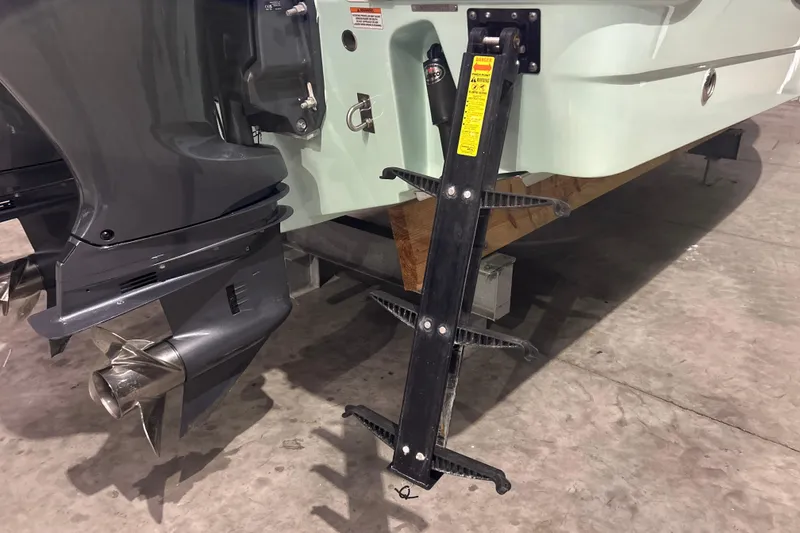 Slide: The Image of 2023 Robalo R242 Center Console boat with ladder and outboard motor. - 29