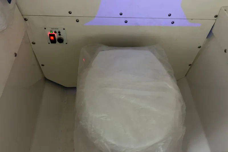 Slide: The Image of 2023 Robalo R242 Center Console boat toilet with control panel. - 30