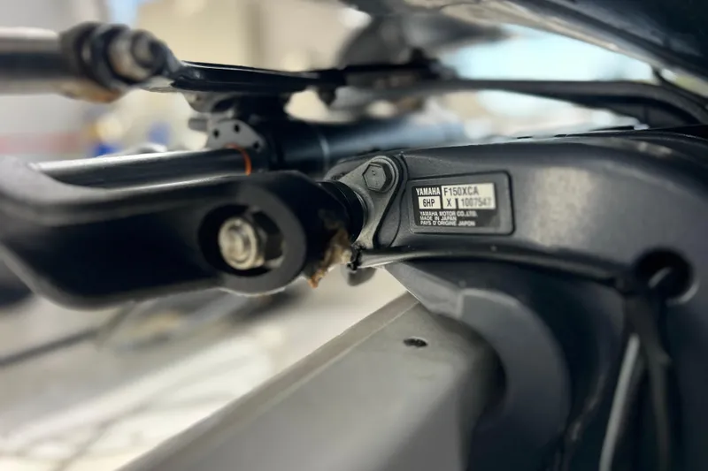 Slide: The Image of Close-up of Yamaha F150XCA engine part on 2023 Robalo R242 Center Console boat. - 38