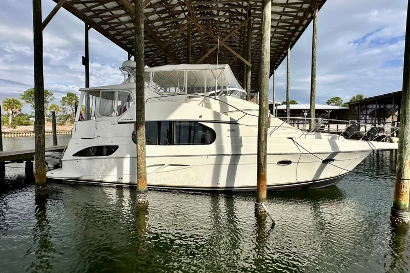 The Image of 2005 Silverton 43 Motor Yacht docked under a covered marina. - 0